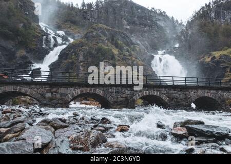 Latefossen Waterfall, unique waterfall with stone bridge. Twin waterfall water close-up in the Odda valley, Ullensvang Municipality in Vestland County Stock Photo