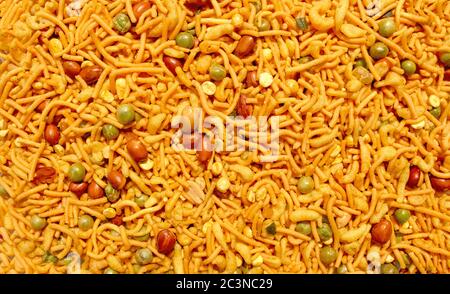 Indian mix snack, Traditional Indian deep fried salty dish called chivda or mixture or farsan made of gram flour and mixed with dry and roasted nuts w Stock Photo