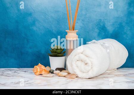 Spa objects and elements on a marble table and blue background Stock Photo