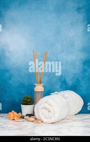 Spa objects and elements on a marble table and blue background Stock Photo