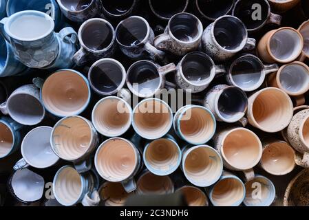 Many colorful ceramic hand made cups, top view. Handmade craft Stock Photo