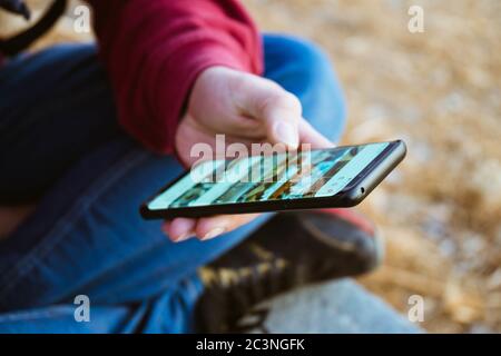 Selective focus shot of a male hand using his phone Stock Photo