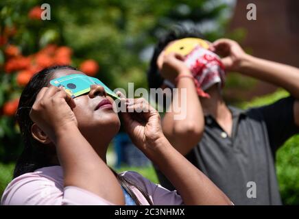 Guwahati, Assam, India. 21st June, 2020. Girl view the annular solar eclipse using special filters, in Guwahati. Credit: David Talukdar/ZUMA Wire/Alamy Live News Stock Photo
