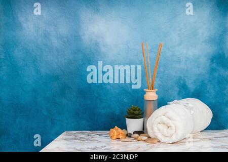 Spa objects and elements on a marble table and blue background Stock Photo