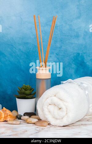 Spa objects and elements on a marble table and blue background Stock Photo