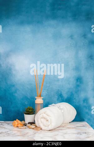 Spa objects and elements on a marble table and blue background Stock Photo