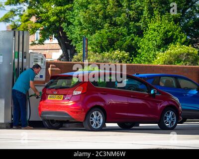 During the Corona Virus Pandemic the kiosk at this supermarket filling station is closed but drivers can refuel  using payment at the pump by debit or Stock Photo
