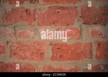 Masonry of red brick macro. Brick wall, rough work. Abstract background close-up Stock Photo