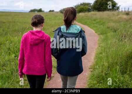 Two young girls take a walk in the countryside Stock Photo