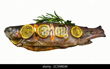 Appetizing, baked trout stuffed with herbs and spices covered with lemon slices on a white background Stock Photo