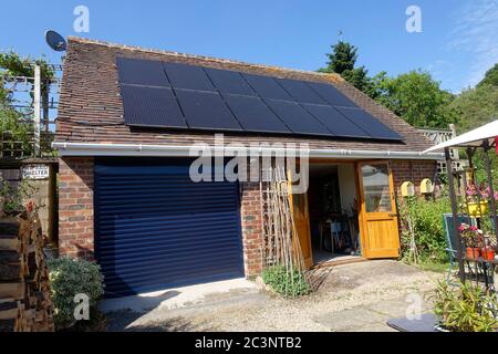 Black solar photovoltaic PV panels installed on garage rook, Bewdley, UK Stock Photo