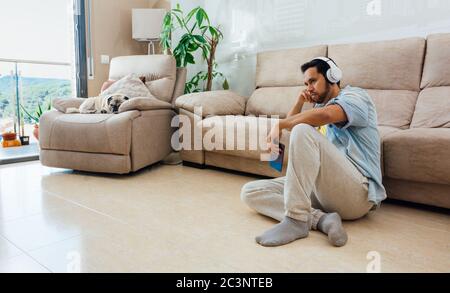 Asian young man with depression sitting on the floor at home Stock Photo