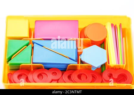 Colorful figures and numbers for children in a box. A tool for developing children's thinking. Stock Photo