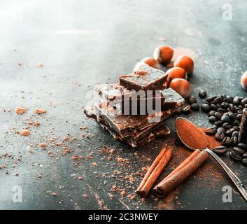 Chocolate, nuts, spices on a smooth black table Stock Photo