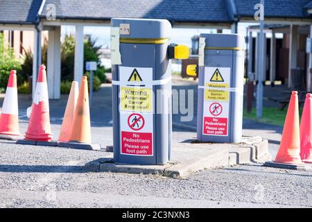 Automatic barrier access control beware bollards and sign Stock Photo