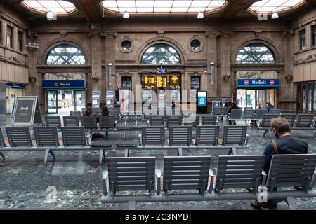 Edinburgh, Scotland, UK. 21 June, 2020. On Monday 22 June it will be mandatory for passengers to wear face coverings when travelling on railways in Scotland. Waverley Station in Edinburgh is preparing by installing warning signs and advisory notices through the station. Many customer service assistants are also on duty to advise the travelling public. Interior of very quiet waiting room.   Iain Masterton/Alamy Live News Stock Photo