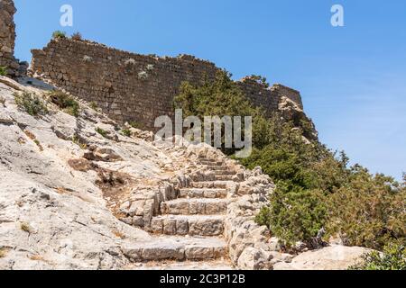 Stairs leading to the top of the rock with the Monolithos castle on the island of Rhodes. Greece Stock Photo