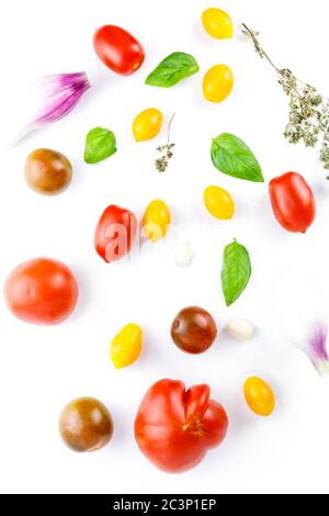 Isolated vegetables mix. Pieces of fresh tomato, cucumber, bell pepper isolated on white background with clipping path Stock Photo