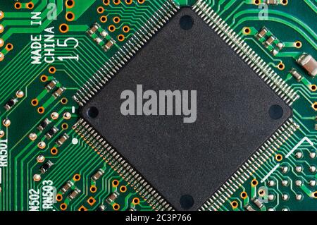 Close-up of electronic circuit board PCB with microchip, processor, integrated circuits, resistances and electronic connections. Stock Photo