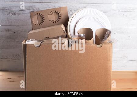 Eco catering plates, cups, boxes and other cardboard products in the box. Stock Photo