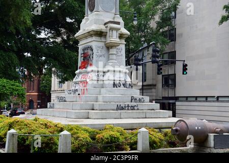Raleigh, NC, United States June 20, 2020 - Graffiti covers the base of the Confederate Civil War memorial after weeks of protests sparked by the police killing of George Floyd. The night before protesters succeed in pulling two figures off of the 75-foot tall column and the next morning the Governor of NC ordered it and two other Confederate monuments to be removed from the grounds of the Old Capitol Building. Stock Photo