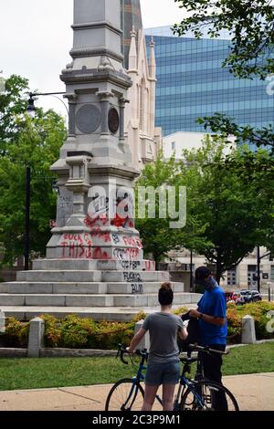 Raleigh, NC, United States June 20, 2020 - Graffiti covers the base of the Confederate Civil War memorial after weeks of protests sparked by the police killing of George Floyd. The night before protesters succeed in pulling two figures off of the 75-foot tall column and the next morning the Governor of NC ordered it and two other Confederate monuments to be removed from the grounds of the Old Capitol Building. Stock Photo