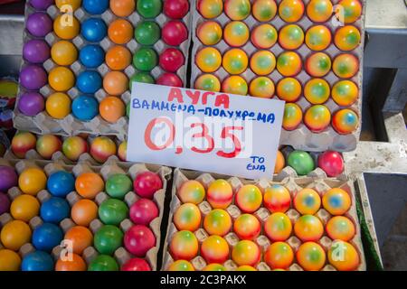 Colorful Easter eggs for sale (In Greek: "Eggs, painted - multi-color"), at a market in Thessaloniki, Greece Stock Photo