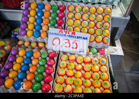Colorful Easter eggs for sale (In Greek: "Eggs, painted - multi-color"), at a market in Thessaloniki, Greece Stock Photo