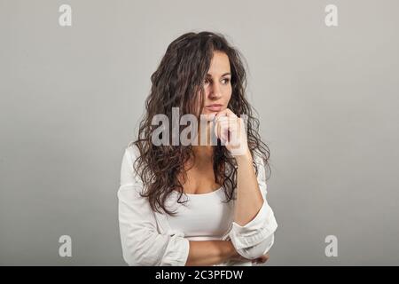Hand on chin thinking question, pensive expression. Doubt. Thoughtful face Stock Photo
