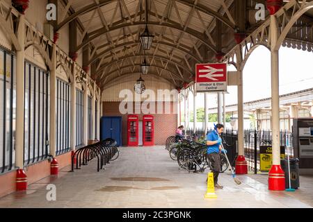 Windsor, Berkshire, UK. 21st June, 2020. A cleaner at work outside Windsor and Eton Central Station as hygiene measures are stepped up following the Coronavirus Pandemic lockdown. Credit: Maureen McLean/Alamy Stock Photo