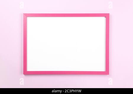 Pink rectangular frame with empty clean white center on pastel pink background, copy space. Flat lay or side view, minimal style mockup. For gift shop Stock Photo