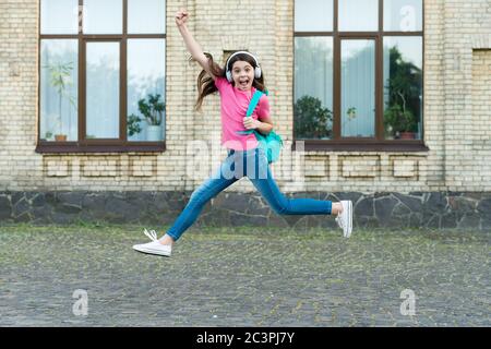 Energetic drive. Happy child in energetic jump outdoors. Energetic mood. Music and entertainment. School holidays. Summer vacation. Healthy and energetic. Stock Photo
