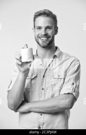 Overpowering mens scent. Happy guy hold perfume bottle yellow background.  Advertising perfume. Eau de toilette. Cosmetic product. Cosmetics. Perfume  and cologne. Shop fragrance perfume, copy space Stock Photo - Alamy
