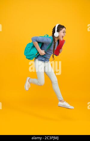 Chase your dream. Energetic kid hurry to school. Happy child in energetic jump yellow background. Energetic mood. Healthy and energetic. School essentials. Hie yourself to back to school sale. Stock Photo