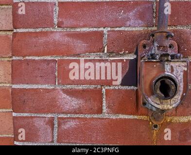 Awning crank on and abandoned brick building Stock Photo