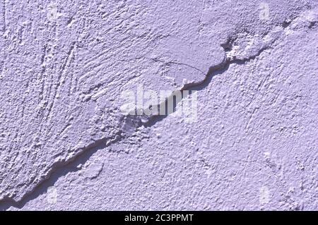 White wall with a rough shape on it that forms a diagonal that divides the image into two parts Stock Photo