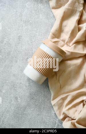 Takeaway reusable bamboo coffee cup on concrete stone table top view. Zero waste, sustainable lifestyle concept. Stock Photo
