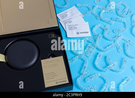 Invisalign transparent retainers with a blue box on the white table ...