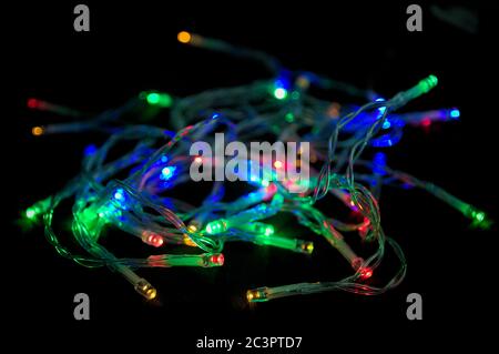 Image of some brightly colored LEDs lit on a dark background indicating energy expenditure, holidays, Christmas Stock Photo