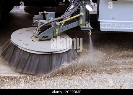 Street sweeper machine cleaning the streets in utility service on the town. Stock Photo