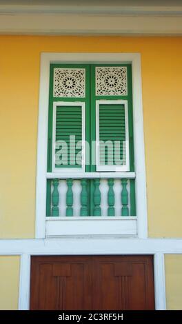 Detail from a balcony on yellow wall in the neighborhood Las Penas. It is known for its colonial architecture Stock Photo