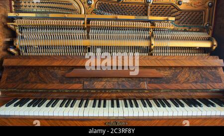 Front view of a wooden piano with the keyboard open Stock Photo