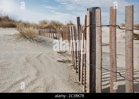 Sand and wind fencing on the sand dunes of North Carolina to help hold the dunes from the movement of the sand and snow all winter Stock Photo