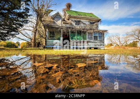 Abandoned farm house with refection in Maryland USA after rain storm Stock Photo