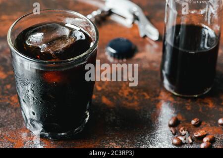 Selective Focus Of Cold Brew Coffee With Ice In Glass And Bottle Near Coffee Beans On Rusty Surface Stock Photo Alamy