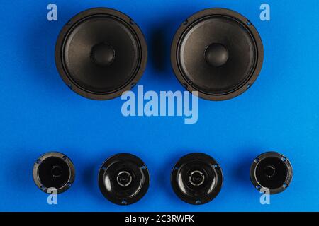 Car audio, car speakers, black subwoofer on a blue background.  Stock Photo