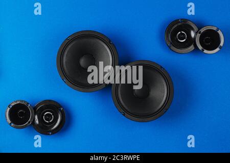 Car audio, car speakers, black subwoofer on a blue background.  Stock Photo