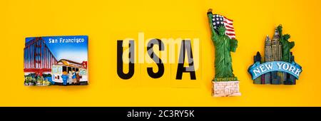 word USA with magnets from new york and san francisco on yellow background, travel destination Stock Photo