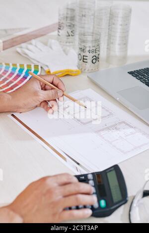 Close-up image of construction engineer drawing blueprint for the project he is working on Stock Photo