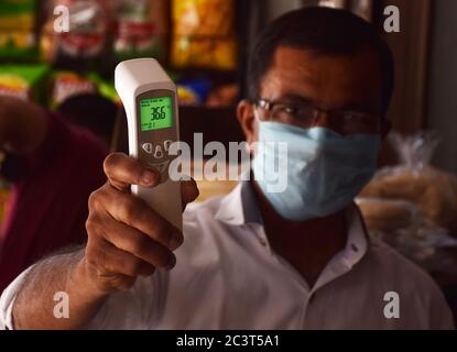 Showing Thermal Forehead Scanner Gun or digital thermometer Stock Photo